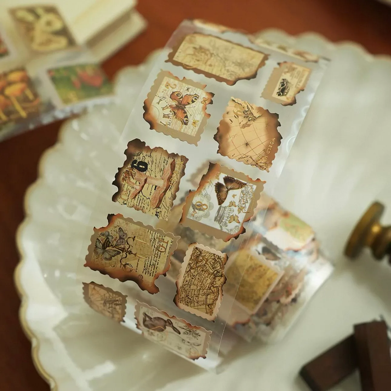 A roll of vintage-style die-cut stamp stickers.