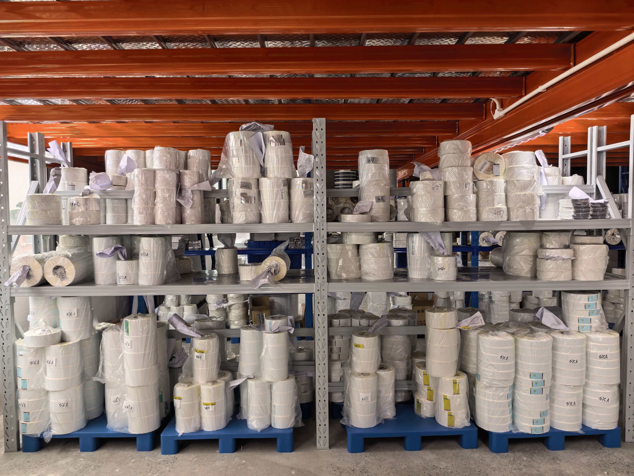 Wrapped finished label rolls organized for order handoff
