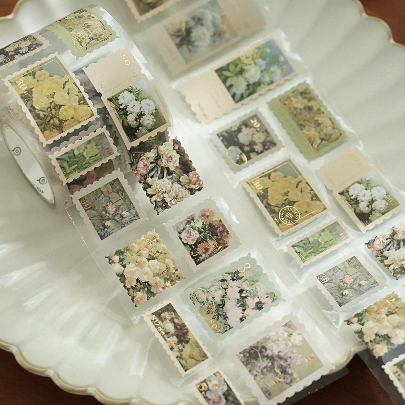 A roll of clear floral labels with shaped die-cut edges.