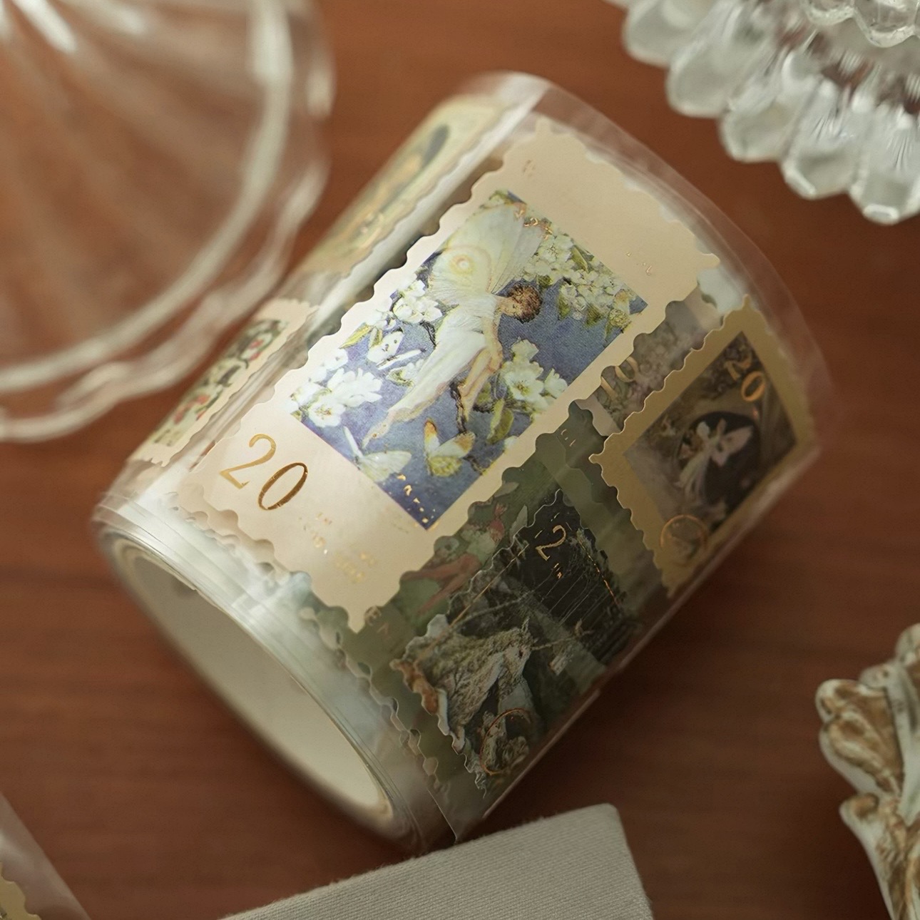A roll of clear labels with gold decorative artwork and shaped edges.